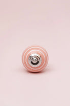 White Striped Ceramic Cabinet Knob in Pastel Pink and Yellow — close-up view, G Decor